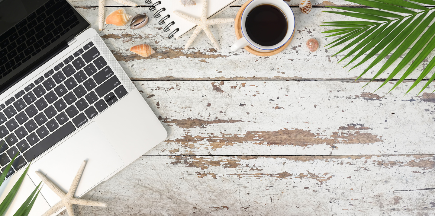 White Ceramic Mug on Beside Laptop Computer